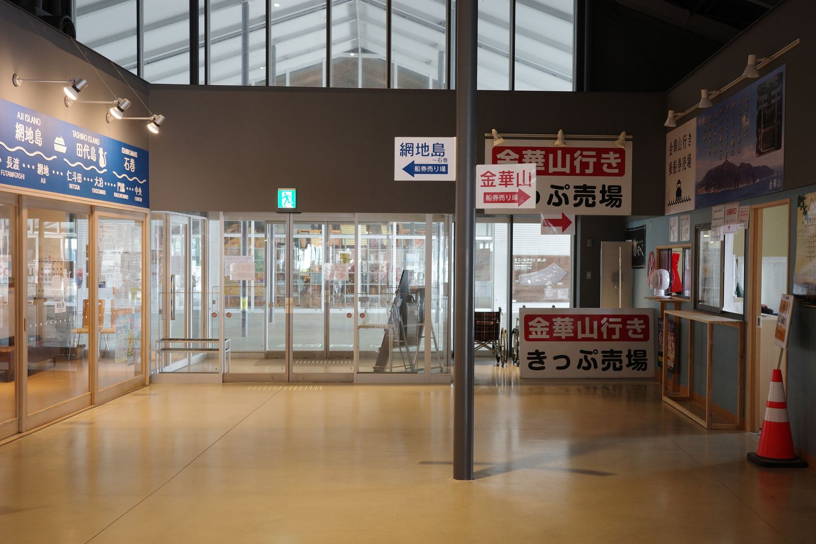 ホエールタウンおしかの館内。「金華山行き きっぷ売場」「網地島」などの案内看板が並んでいる